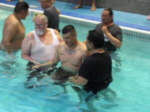 Men getting baptised in the woater at the Keystone Baptism
